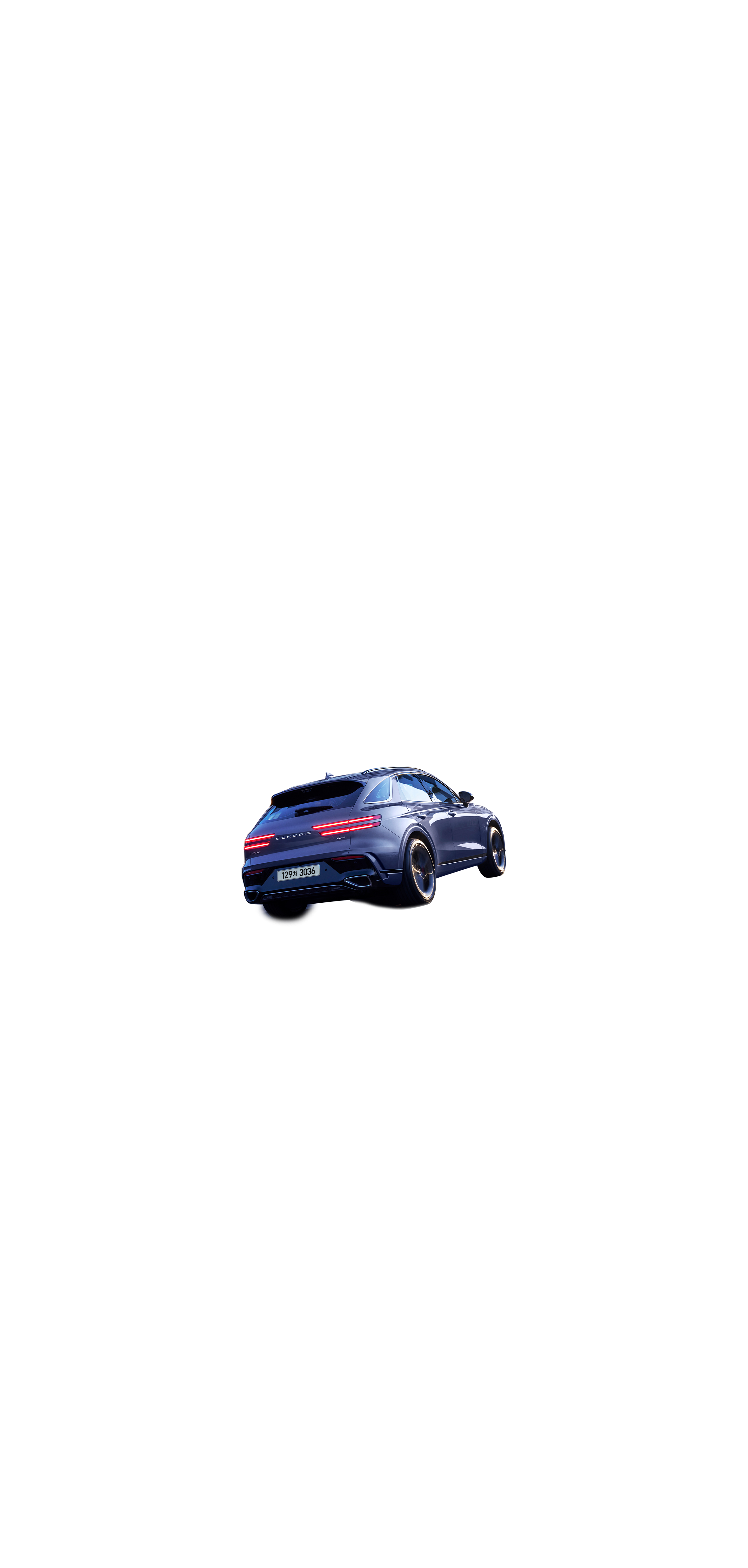 This is a view from the rear of the GV70 driving through a city illuminated by city lights at night.